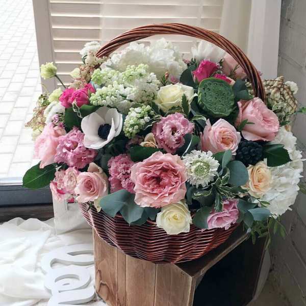 Basket of pink and white flowers with roses and anemones