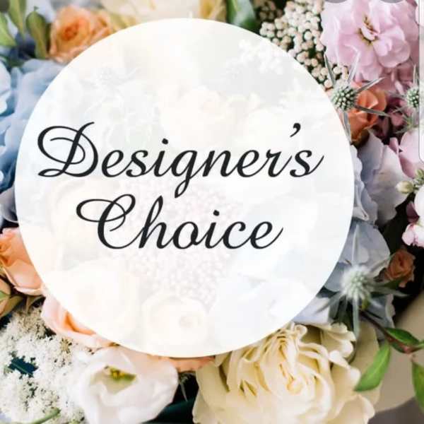 Pastel floral arrangement with a "Designer’s Choice" sign in the center