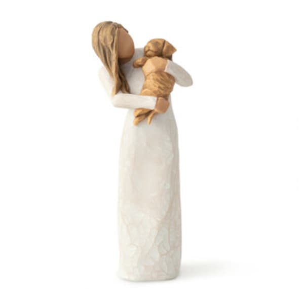 Wooden angel figurine holding a small child