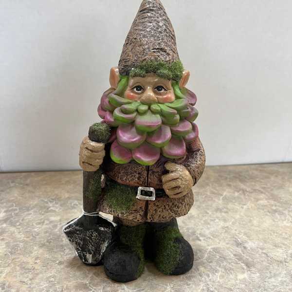 Garden gnome figurine holding a shovel