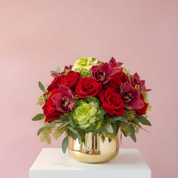 Red roses and burgundy orchids in a gold vase