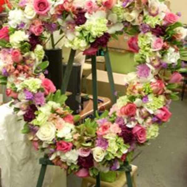 Heart-shaped floral wreath with pink, white, and purple blooms