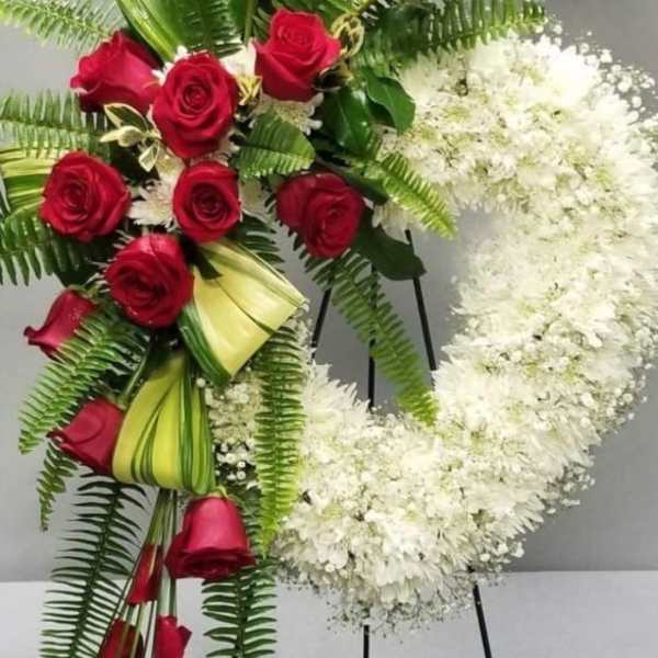 Red roses and white flowers arranged on standing easels
