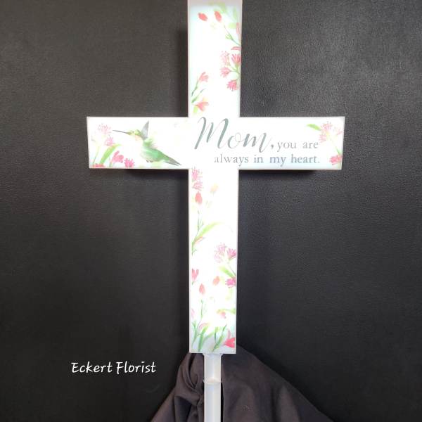 White memorial cross with floral print and the words "Mom, you are always in my heart."
