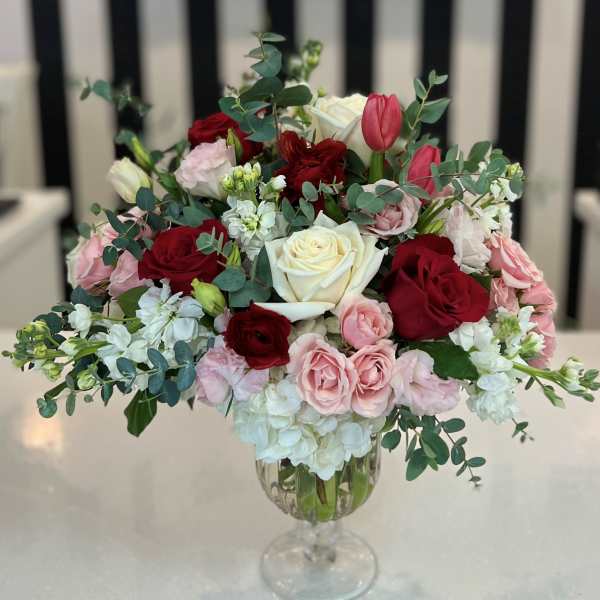 Mixed roses and tulips in a clear glass vase
