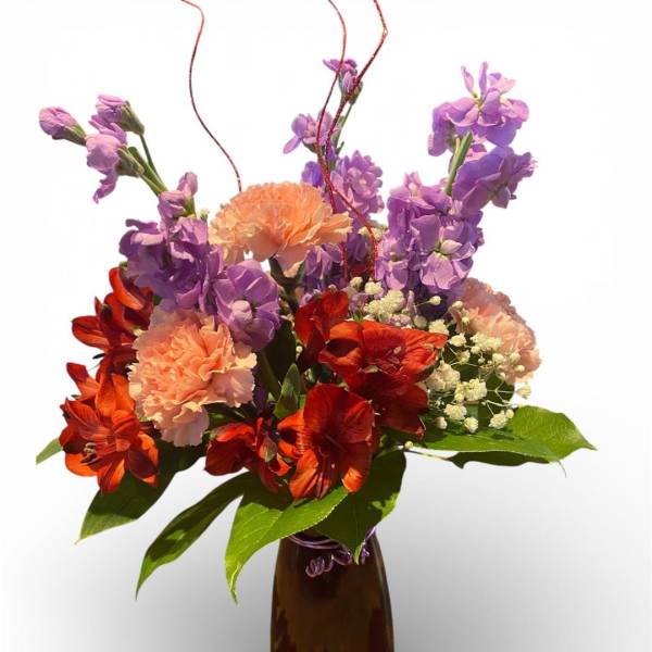 Bouquet of purple and orange flowers in a brown vase