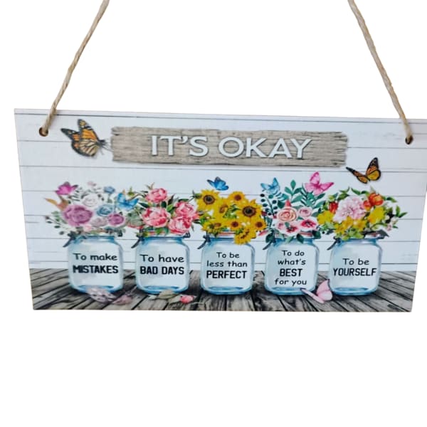 Decorative hanging sign with painted flower jars and the words "IT'S OKAY"