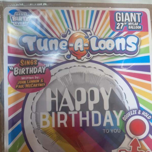 Packaged birthday mylar balloon with rainbow stripes and "Happy Birthday" text