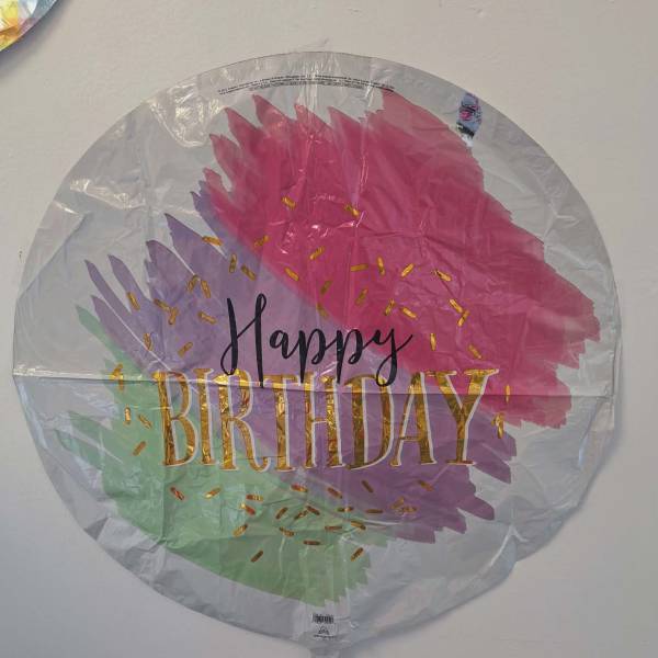 Round foil Happy Birthday balloon with pink, purple, and green brushstroke design