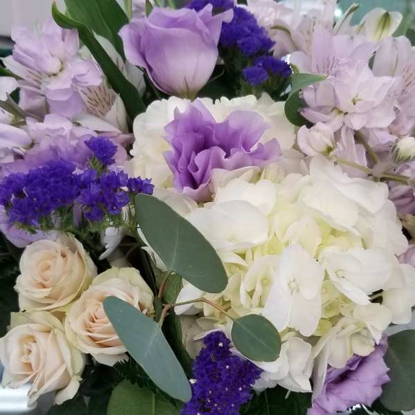 Lavender and white bouquet with roses, hydrangeas, and lilies