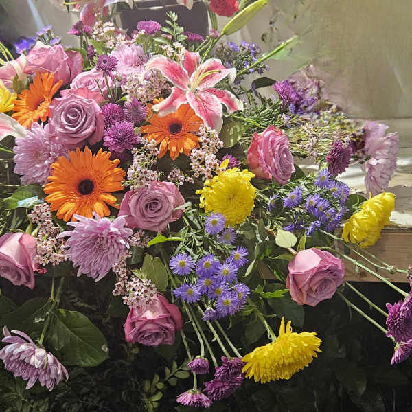 Mixed bouquet with pink roses, lilies, gerberas, and purple flowers
