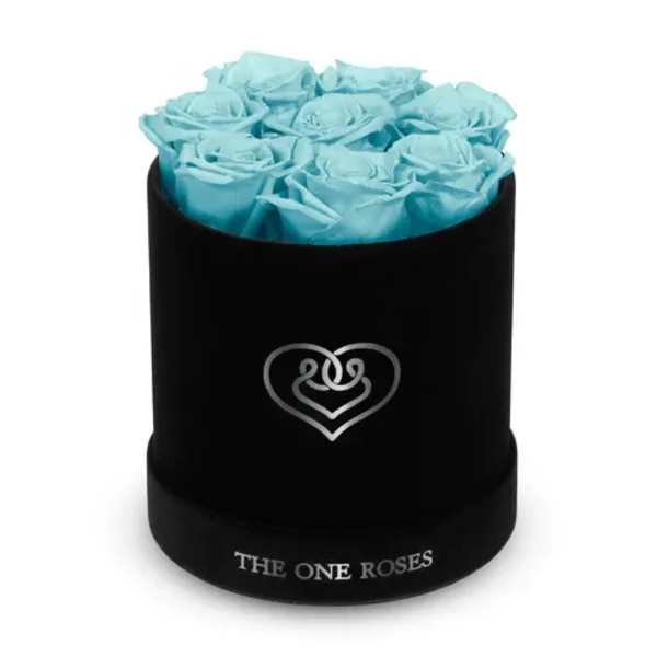 Blue roses arranged in a black round box