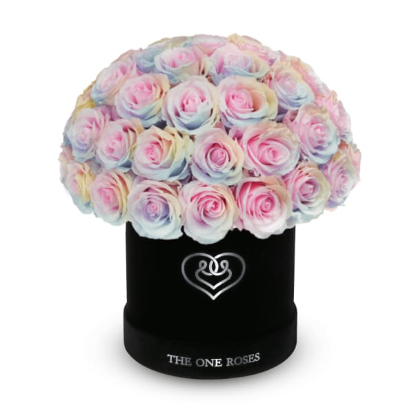 Pastel rainbow roses arranged in a black round box