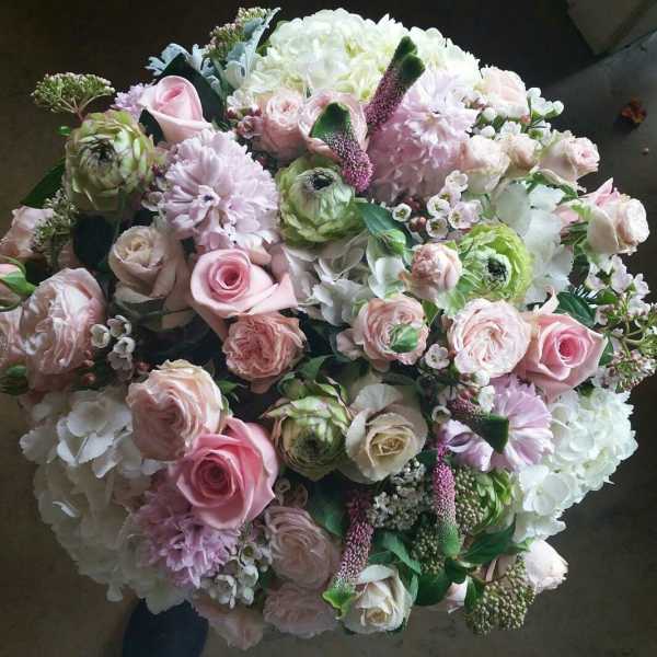 Large bouquet of pale pink and white flowers with roses and hydrangeas