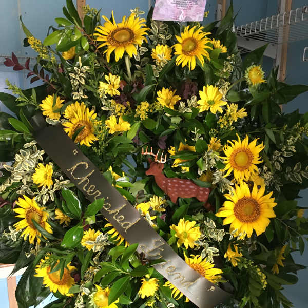 Large sunflower wreath with a black memorial ribbon and deer ornament