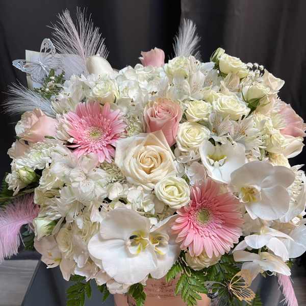 Large bouquet of white and pink flowers in a pink hatbox