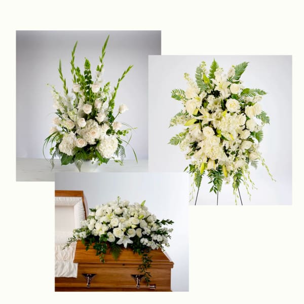 Set of white funeral arrangements with roses and lilies including vase, standing spray, and casket spray.