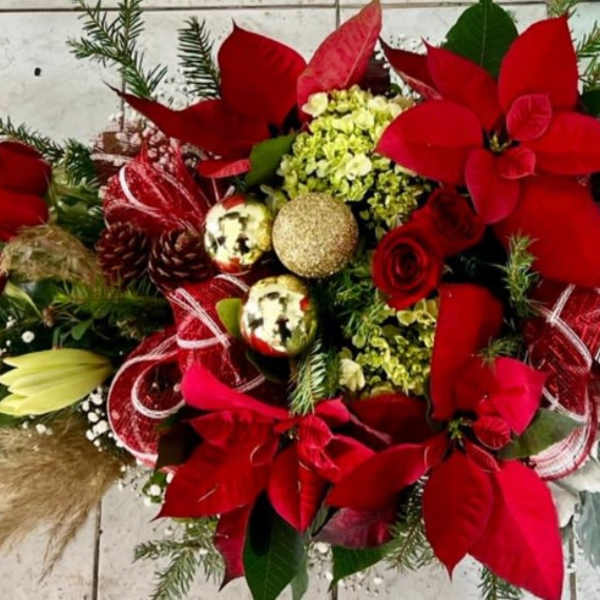 Red poinsettia arrangement with roses, lilies, and gold ornaments