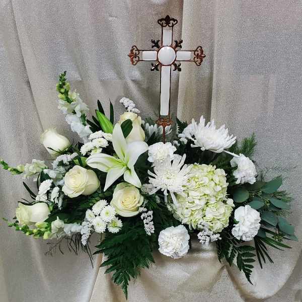 White floral spray with a decorative cross centerpiece