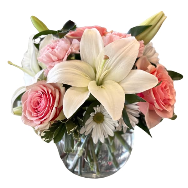 Pink roses and white lilies in a clear glass vase