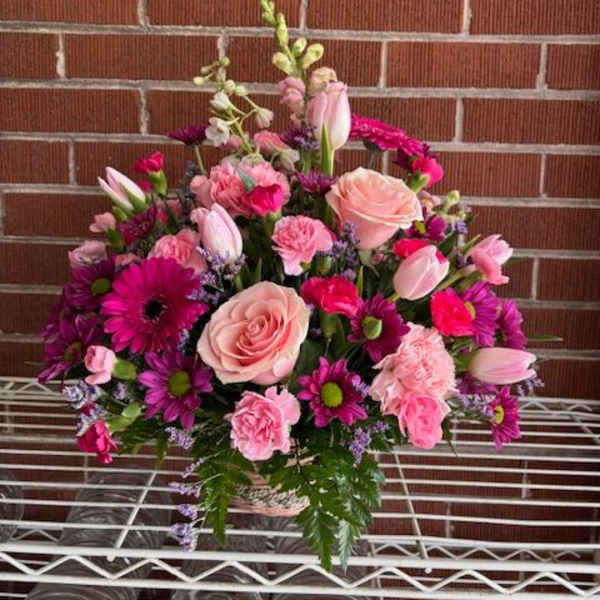 Pink and purple mixed flower arrangement with roses and tulips