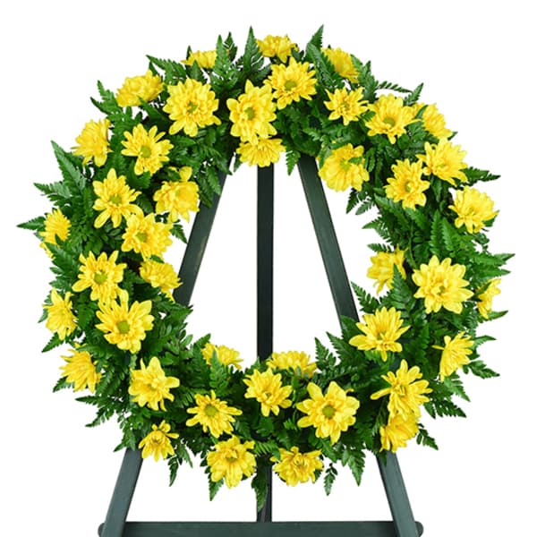 Yellow daisy wreath on a black easel stand