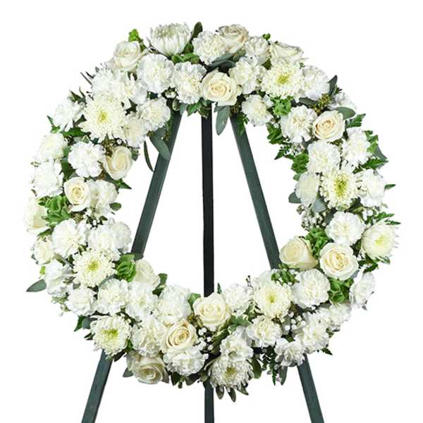 White floral wreath on a standing easel