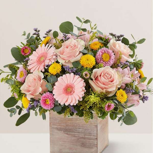 Pink roses and daisies in a wooden box arrangement