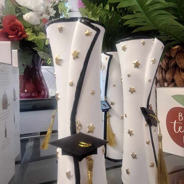 Graduation-themed decorative cylinders with caps and tassels