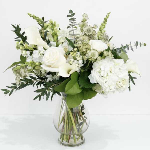 White floral bouquet in a clear glass vase
