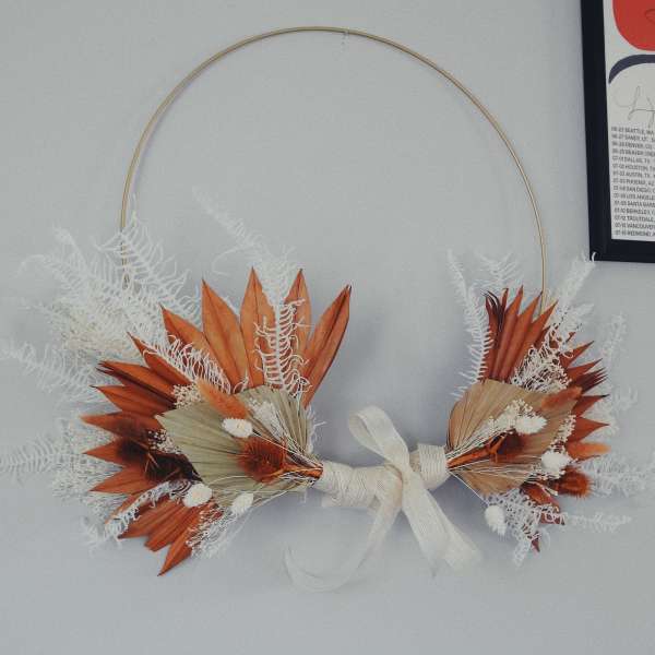 Dried floral hoop wreath with orange and white accents