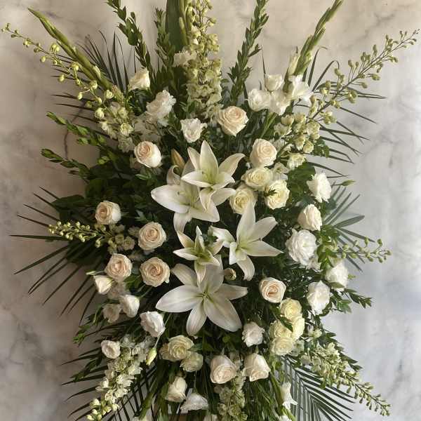 Large white floral standing spray with lilies and roses
