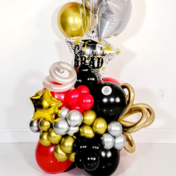 Graduation balloon tower with black, gold, red, and silver balloons