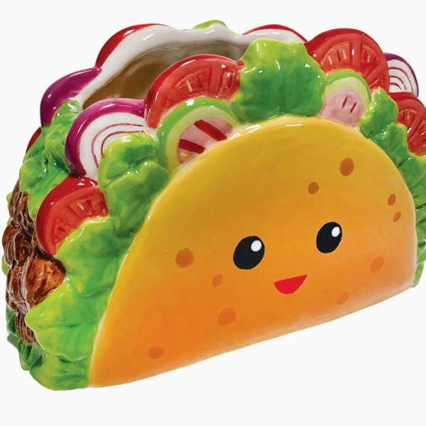 Taco-shaped decorative pillow with a smiling face
