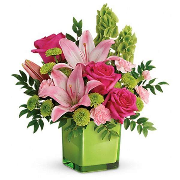 Pink roses and lilies in a green square vase