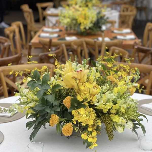 Yellow floral centerpiece on a round table