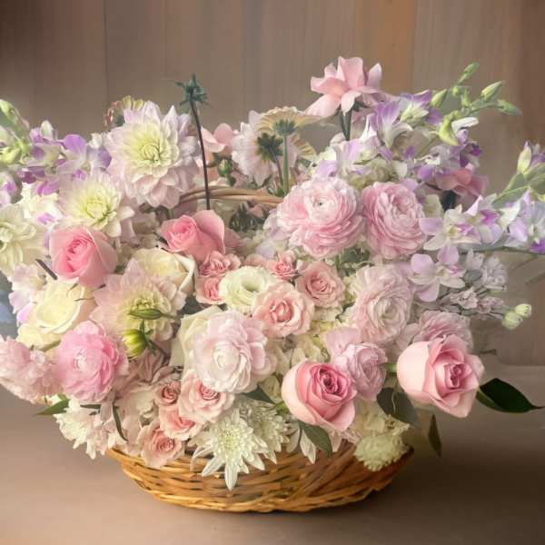 Basket arrangement of pink and white flowers with lavender accents