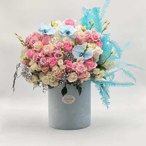 Pink and white rose bouquet in a pale blue box with blue accents