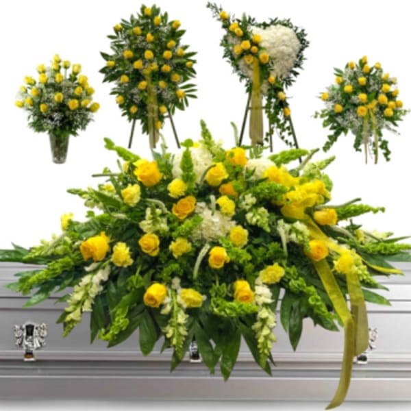 Yellow rose funeral spray on a white casket