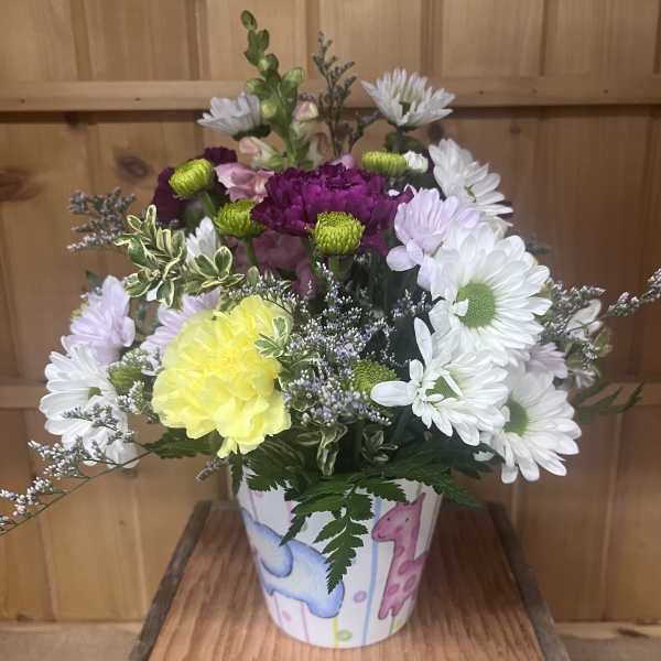 Mixed bouquet in a decorated paper pot with white, purple, and yellow flowers