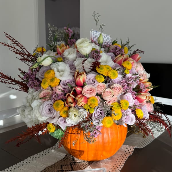 Mixed floral arrangement in a carved pumpkin container