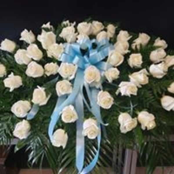 White rose wreath with a blue ribbon bow