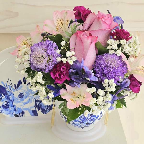 Pink and purple bouquet in a blue-and-white ceramic vase