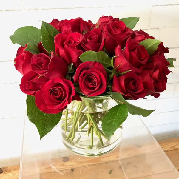 Bouquet of red roses in a clear glass vase