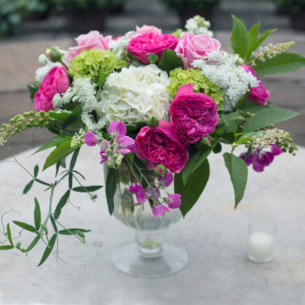 Pink and white floral arrangement in a clear glass vase