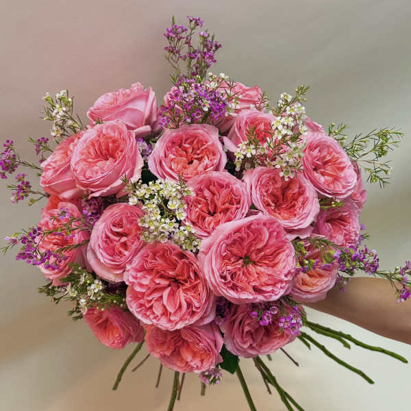 Pink rose bouquet with small purple and white filler flowers