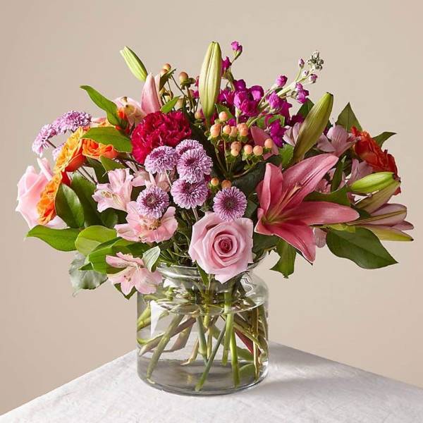 Mixed pink and purple bouquet in a clear glass vase