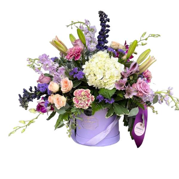 Lavender hatbox arrangement with mixed pink, purple, and white flowers