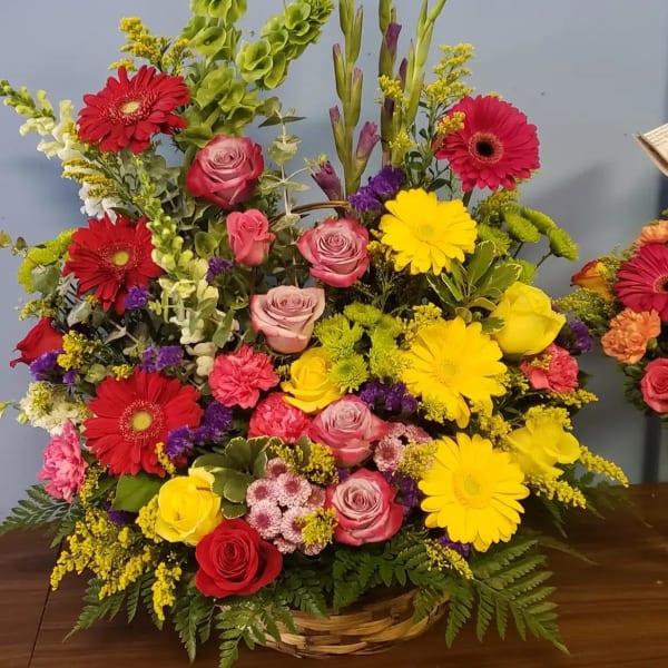 Colorful mixed flower arrangement in a wicker basket