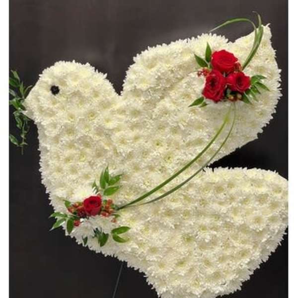 White floral dove-shaped standing spray with red rose accents